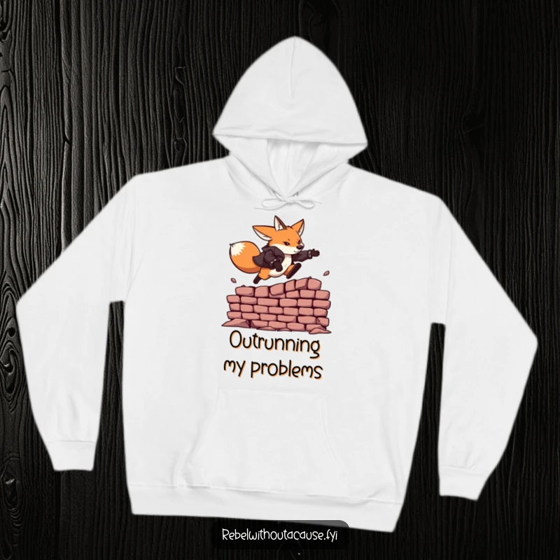 Funny hoodie showcasing a fearless fox in a leather jacket, mid-air leaping over a crumbling brick wall.