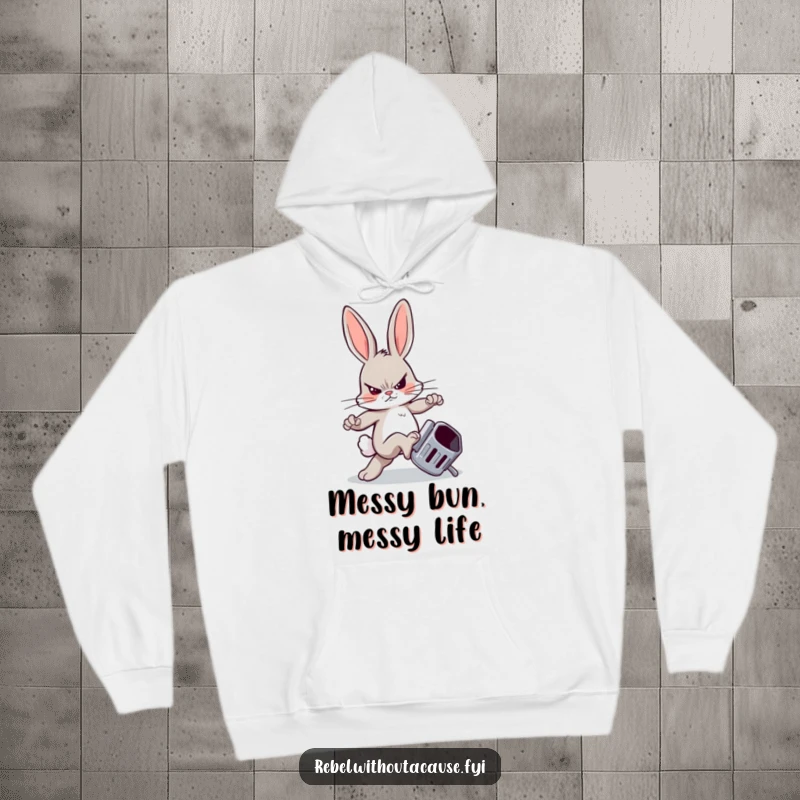 Funny hoodie featuring a rebellious bunny with a sneer, kicking a trash can, for a cozy, humorous vibe.